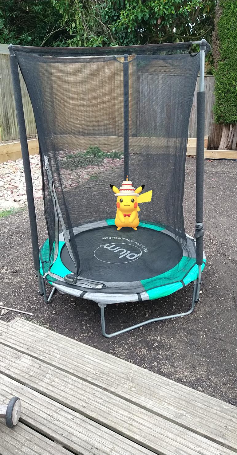 Augmented reality Pikachu sitting on a trampoline