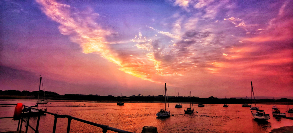 Sunset over harbour with boats