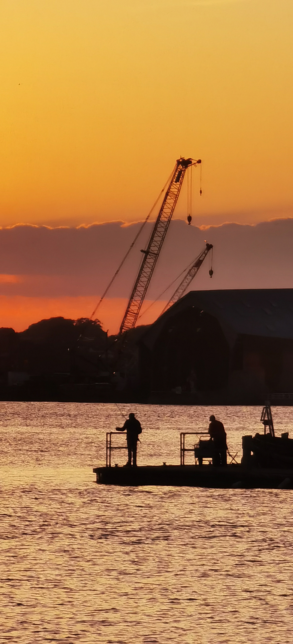 Amazing sunset over fishermen and cranes