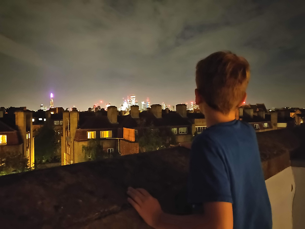 My son in the forground of the picture with the lights of London shing brightly in the background.