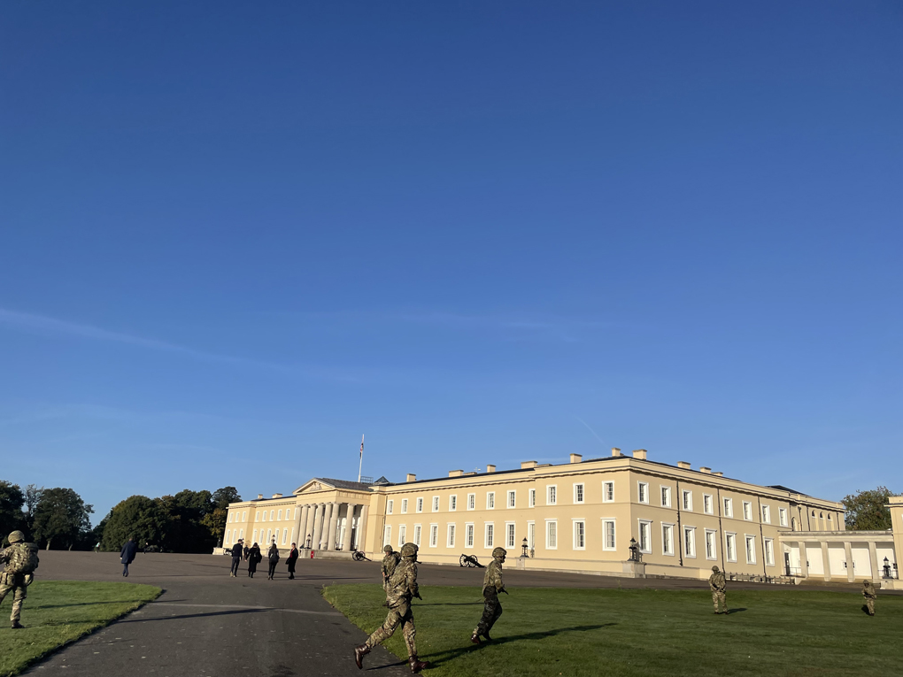 Soldiers training in front of large historical building in the autumn sunshine
