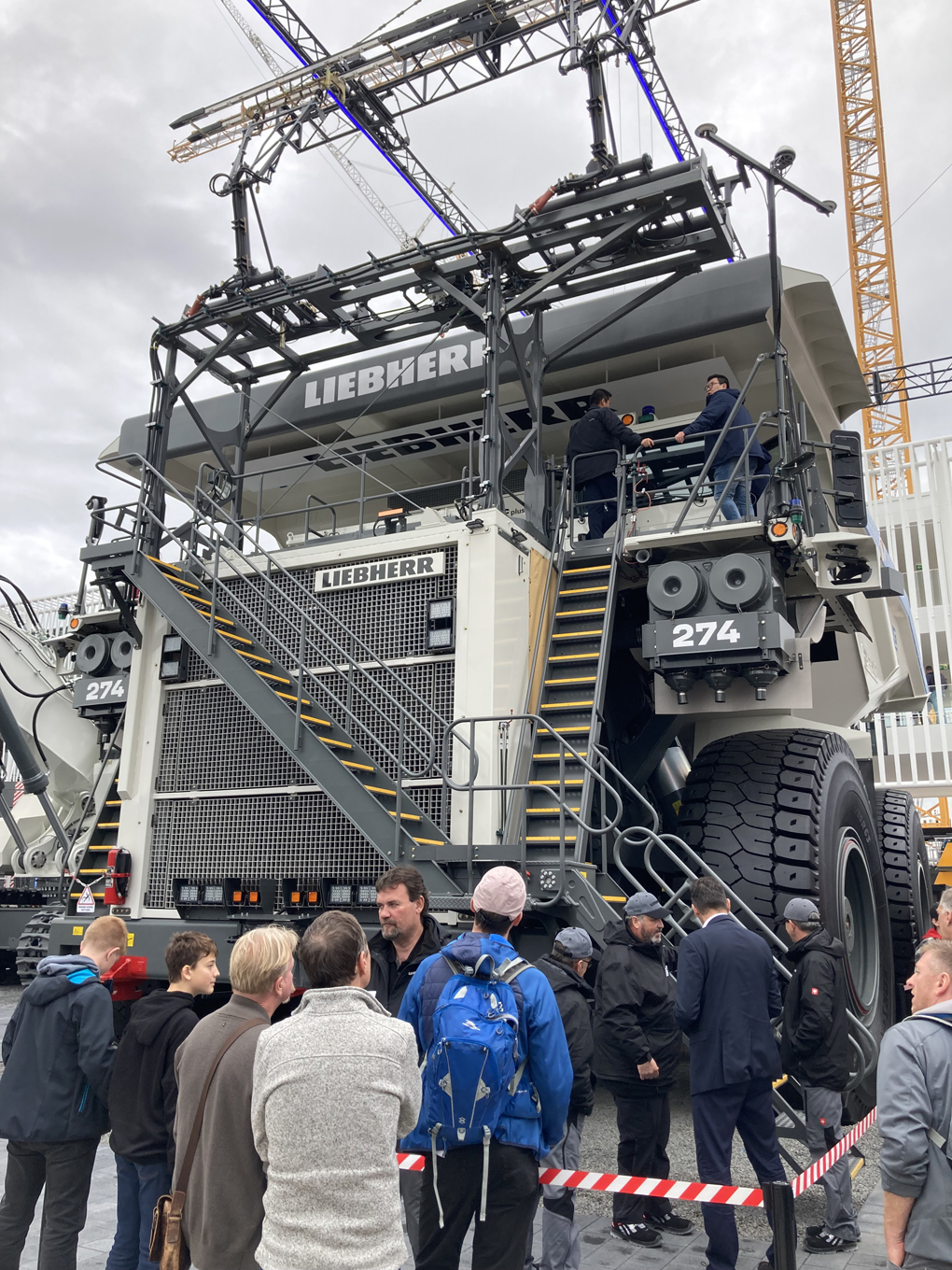 We see the front of a giant mining truch at the Bauma Construction and Mining Trade Fair Munich