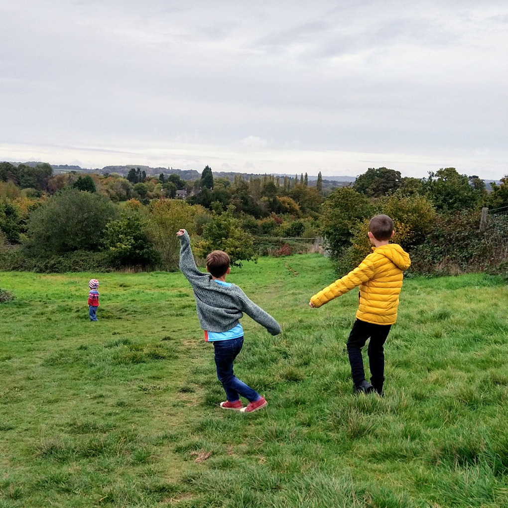 Children playing in open grassland