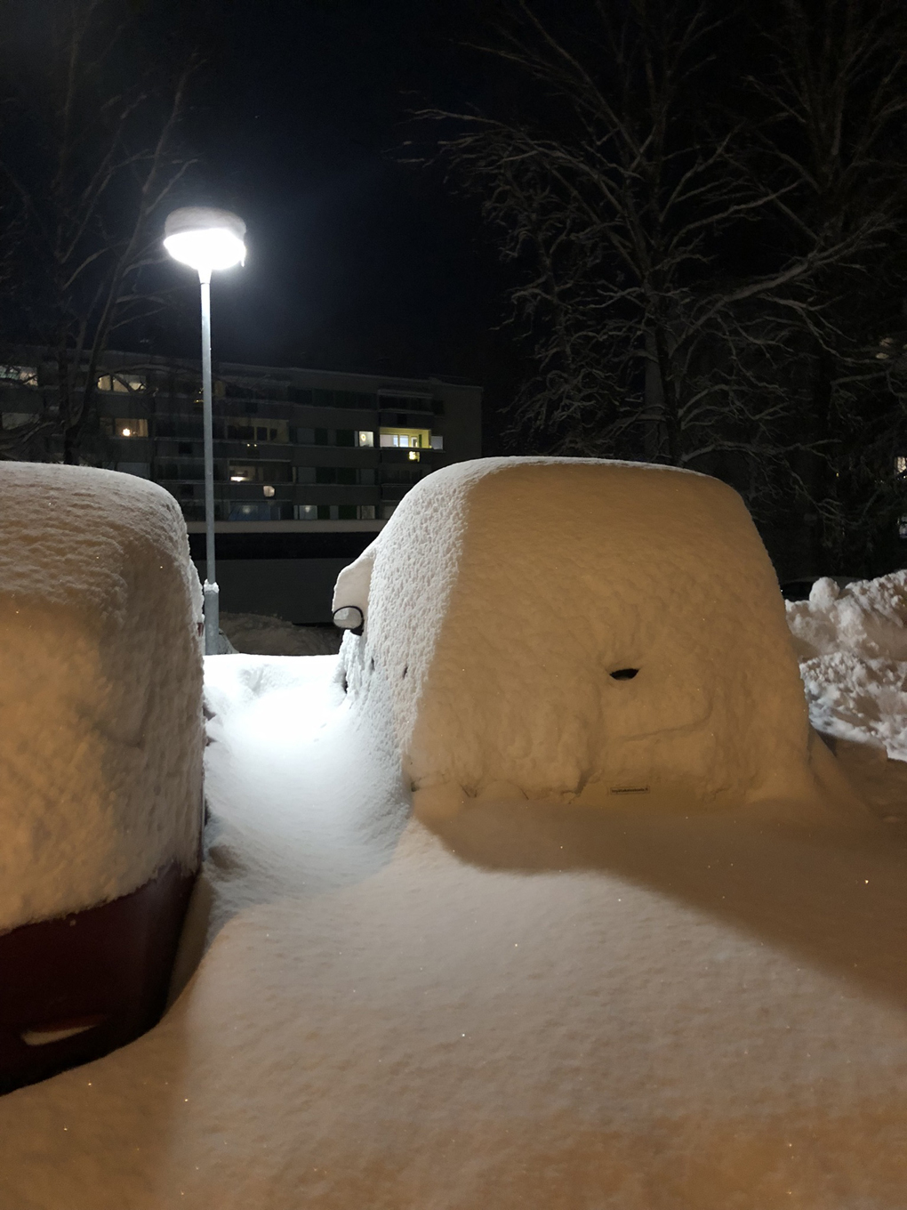 Car completely covered in snow.