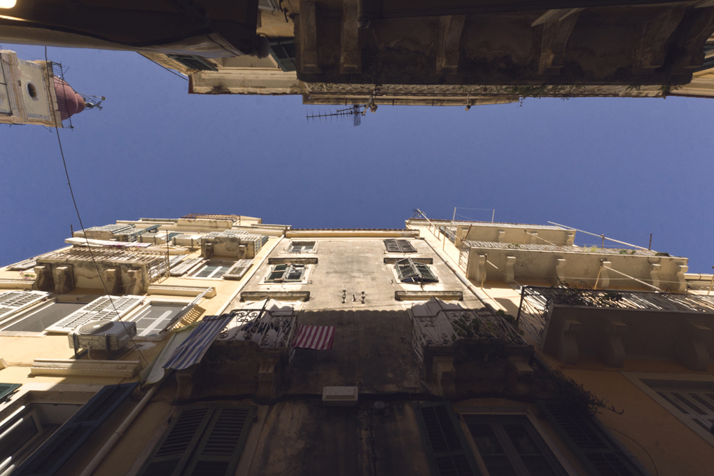 Looking up to the sky down a narrow alley in Corfu Old Town