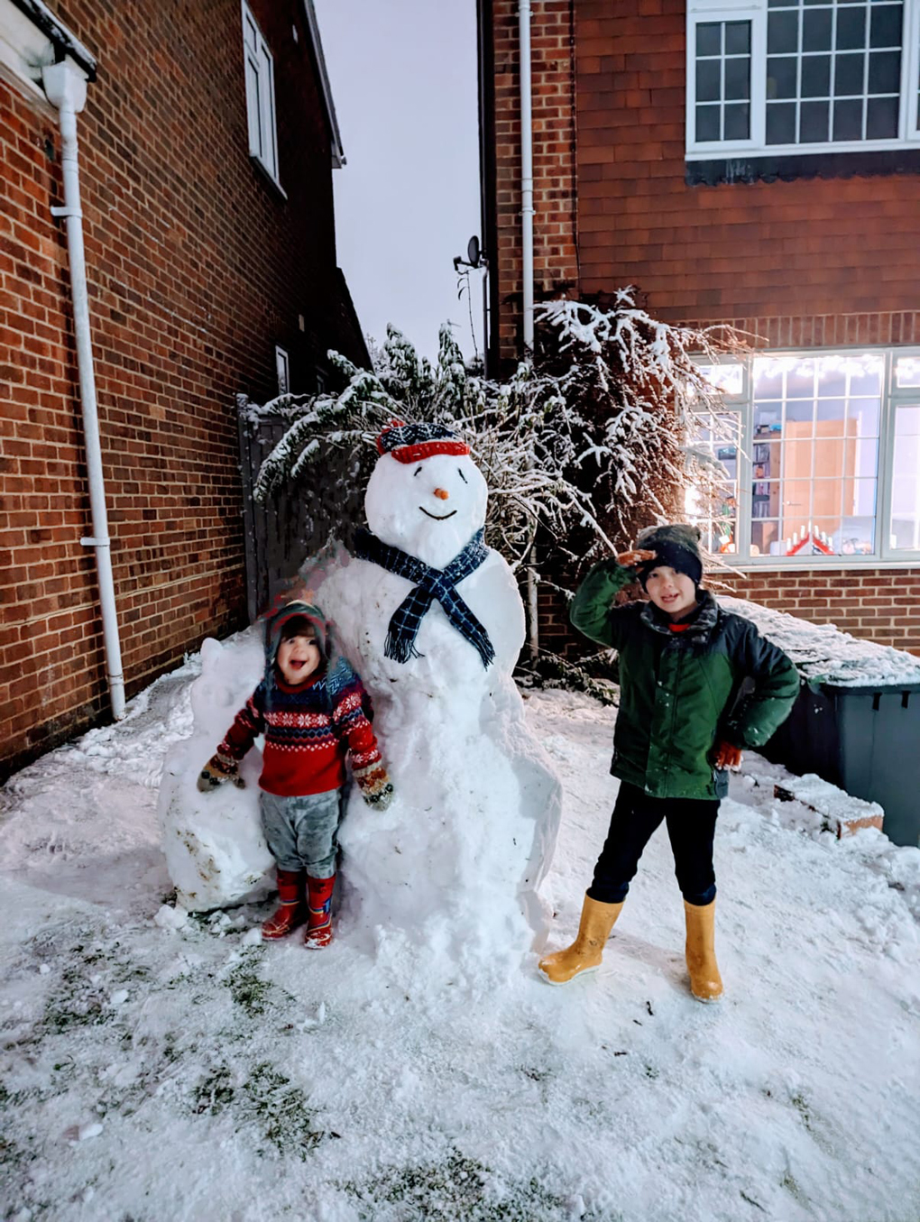 Children by a snowman