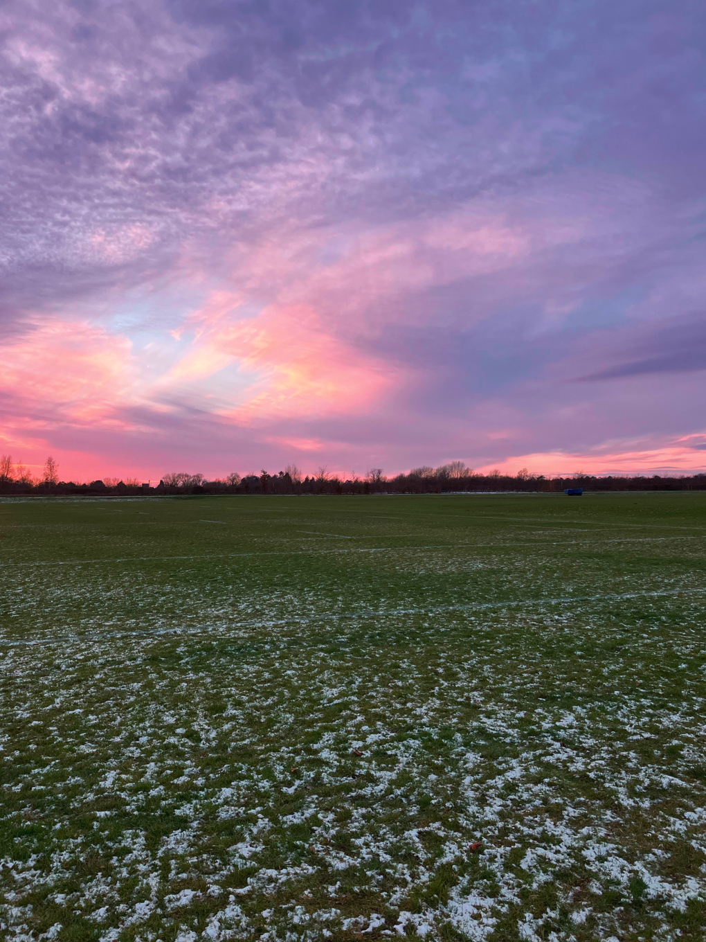 Photo of the sky with red clouds at sunset, you can just see the blue sky peaking through the wispy clouds!