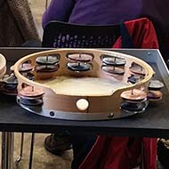 A view from the back of the orchestra showing cymbals and music stands.