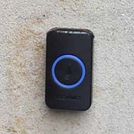 Original georgian doorbell and modern phone-linked doorbell on stone wall