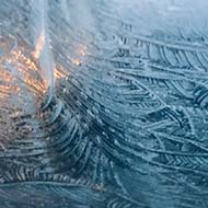 Feather-like ice patterns on a car windscreen
