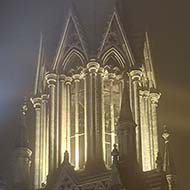 Church tower glowing with light in the fog