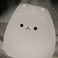 A small glowing light shaped like a rotund cartoon cat