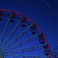 Lit up Ferris wheel in night sky