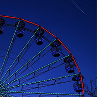 Lit up Ferris wheel in night sky