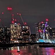 London high-rise buildings along the Thames, lit up at night