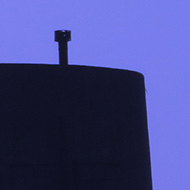 We see the silouhette of a restored WW2 five story observation tower, part of the German fortifications on Guernsey