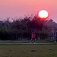 Photo of the sun going down as we walk around the track not far from the house.
