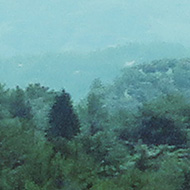 We see the peaks of the Troodos Mountains in Cyprus across a steep green valley