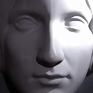 A large, white sculpt of Mary Shelley's face cast in shadow looks down