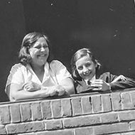 Black and white image of 2 people looking out a window, my grandmother and great-grandmother