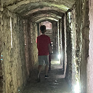 Image of my son Josh walking through one of the illuminated castle corridors.