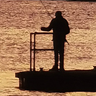 Amazing sunset over fishermen and cranes