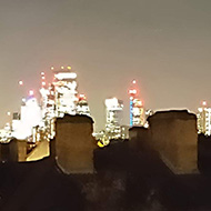 My son in the forground of the picture with the lights of London shing brightly in the background.