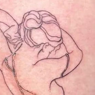 Tattoo of a woman from behind broken and repaired with gold