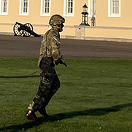 Soldiers training in front of large historical building in the autumn sunshine