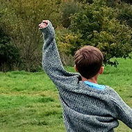 Children playing in open grassland