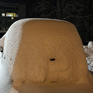 Car completely covered in snow.