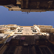 Looking up to the sky down a narrow alley in Corfu Old Town