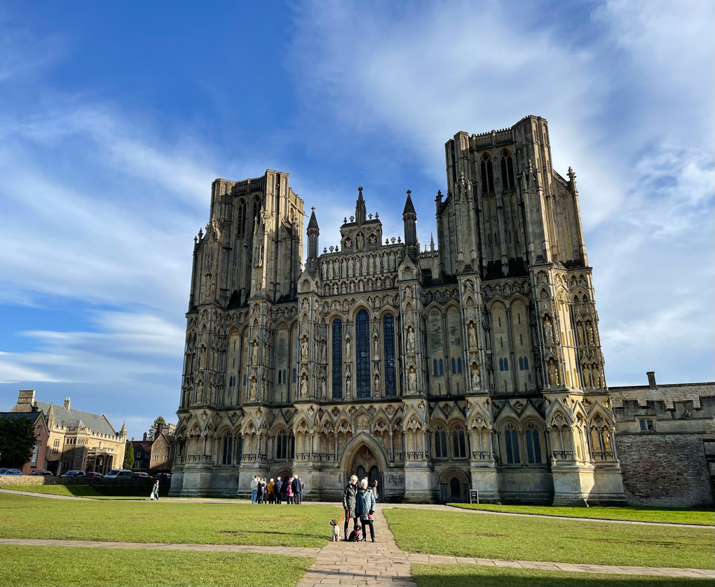 Two people and dogs stood in front of a hide cathedral frontage