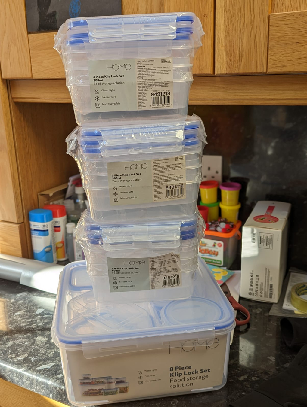 Carefully stacked Tupperware on a kitchen surface