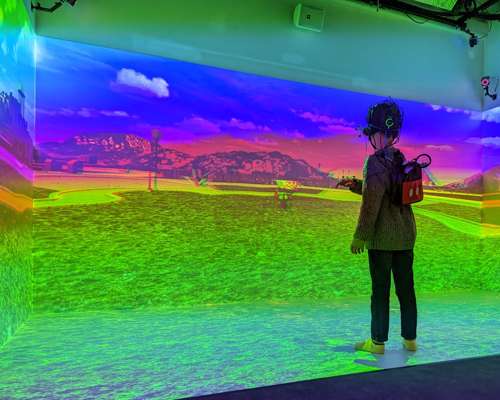 Child in a VR headset in front of a brightly coloured display