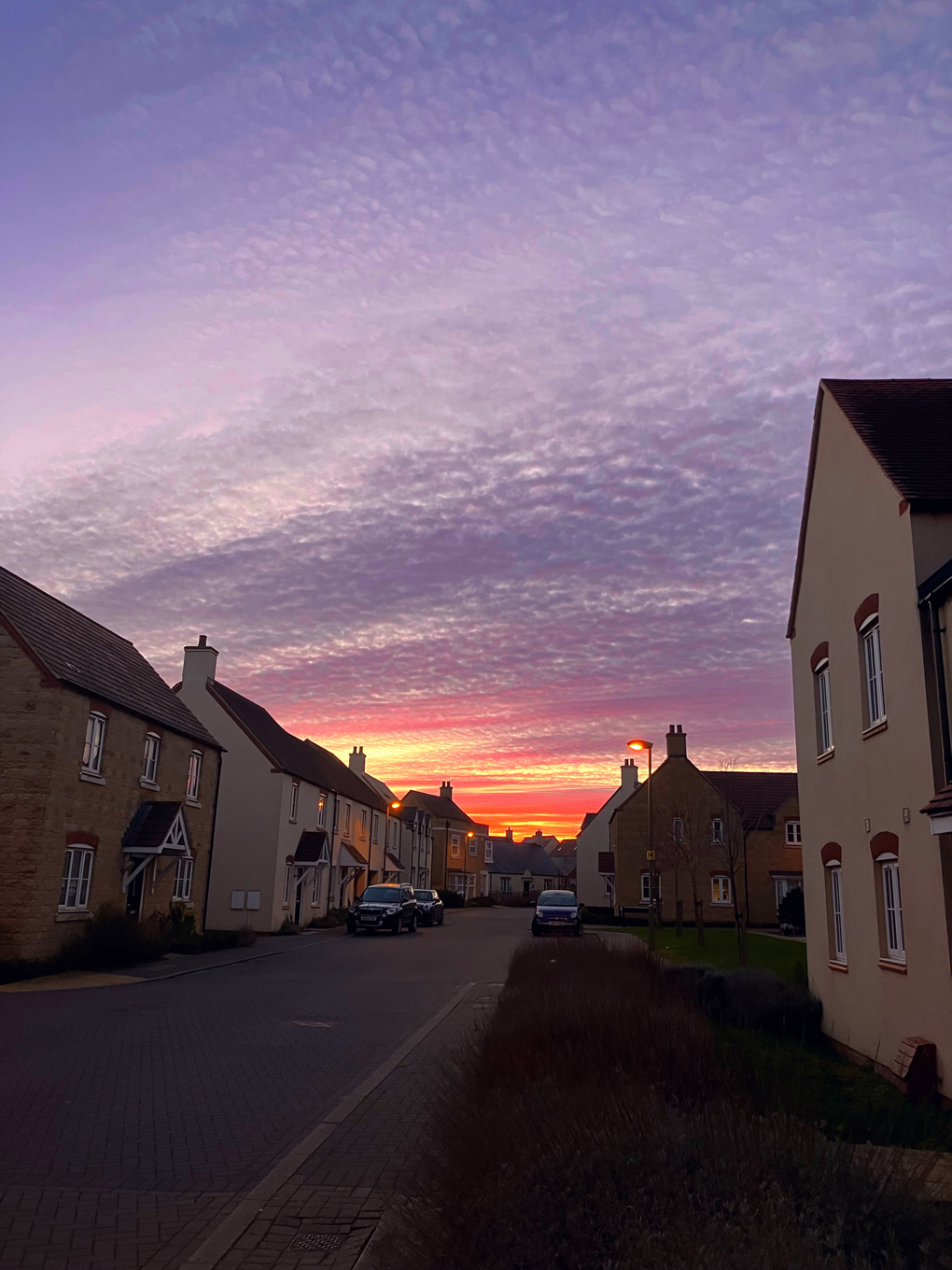 Photo taken at the end of my road, with a sky that looks like it's on fire, beautiful reds, oranges and even some purples.