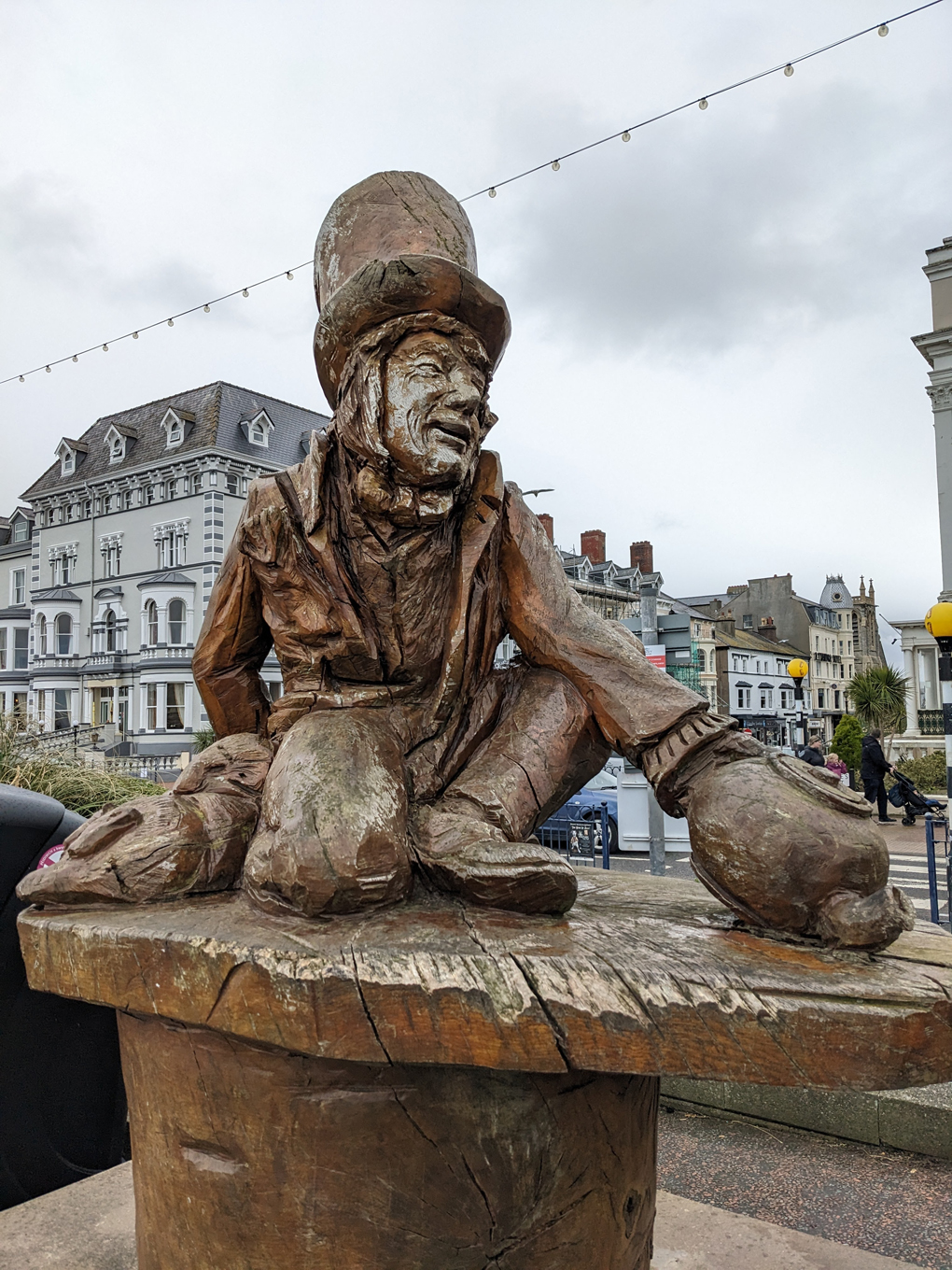 A wooden carving of the Mad Hatter from Alice in Wonderland