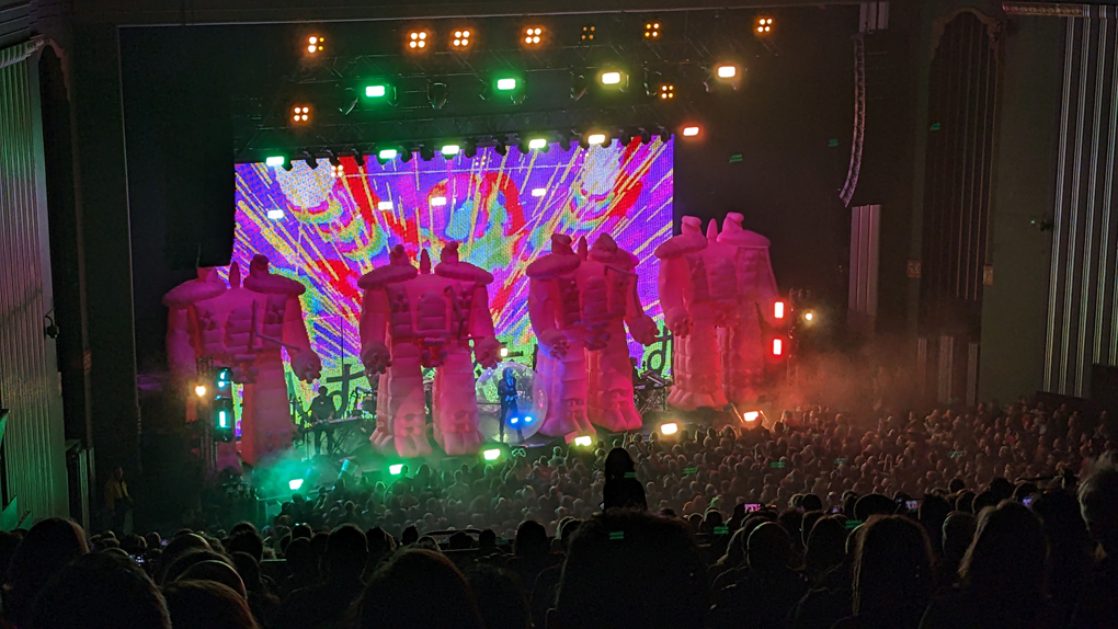 Rock band The Flaming Lips on-stage accompanied by four 20ft tall inflatable robots.