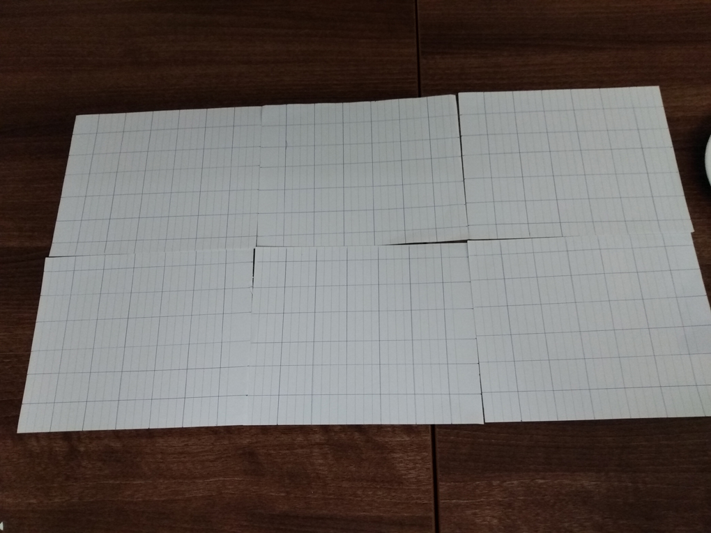 6 sheets of notepad paper have a grid drawn onto them