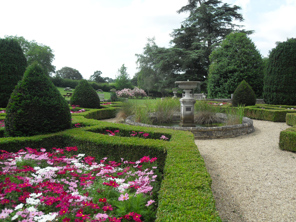 Formal Georgian garden with fountain and summer flowers