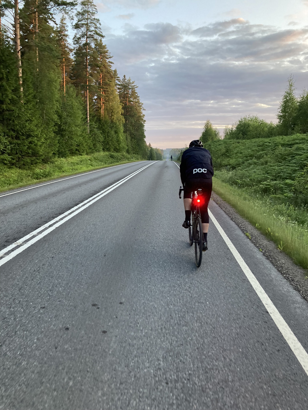 A man cycling on a road.