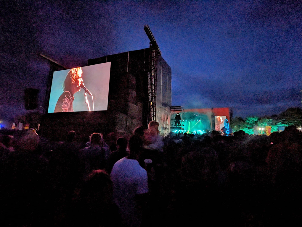 Giant screen over a music festival in the dark