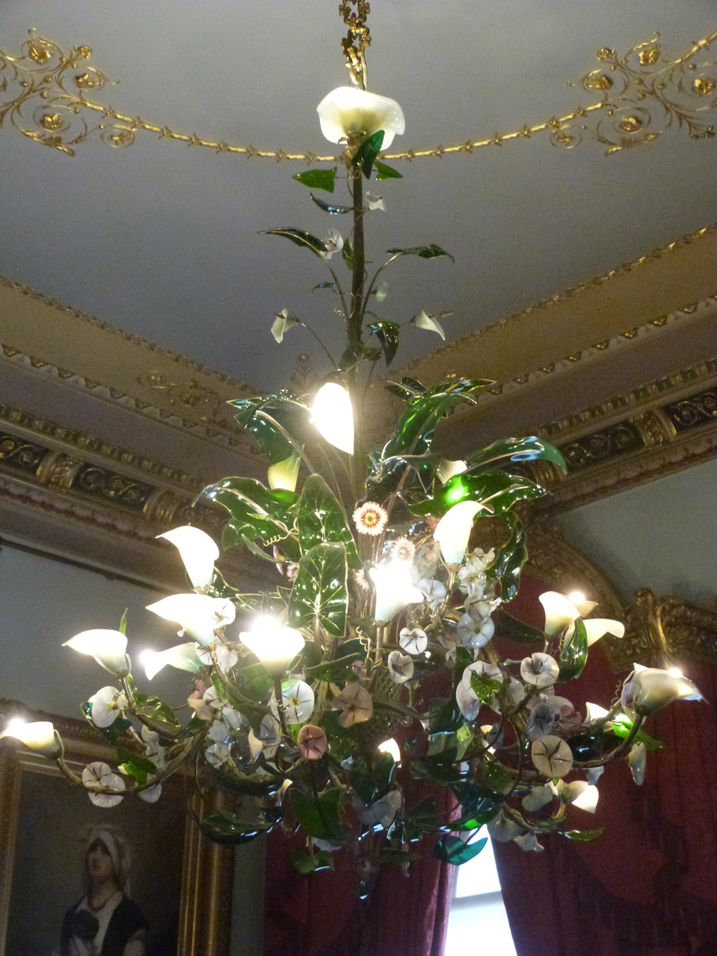 Illuminated lily flowers form part of an extensive floral style chandelier, complete with translucent green leaves, in one of the rooms at Osborne House, Isle of Wight.