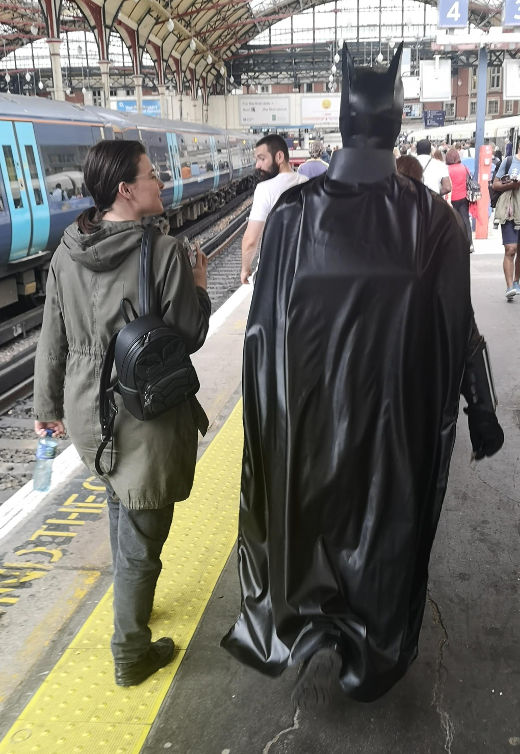Batman walking down a train platform