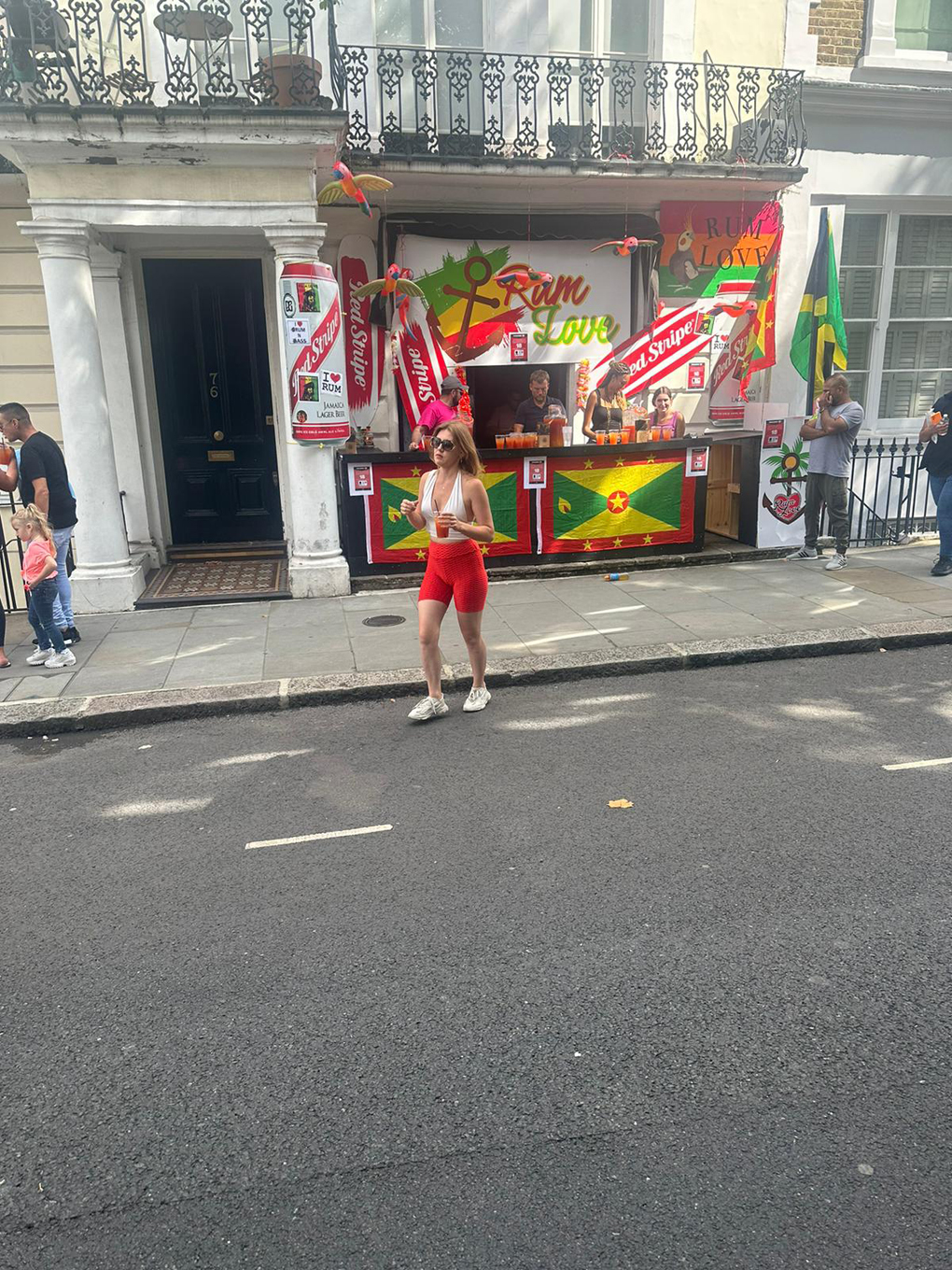 A very colourful stand and seller selling rum at the Notting Hill carnival.