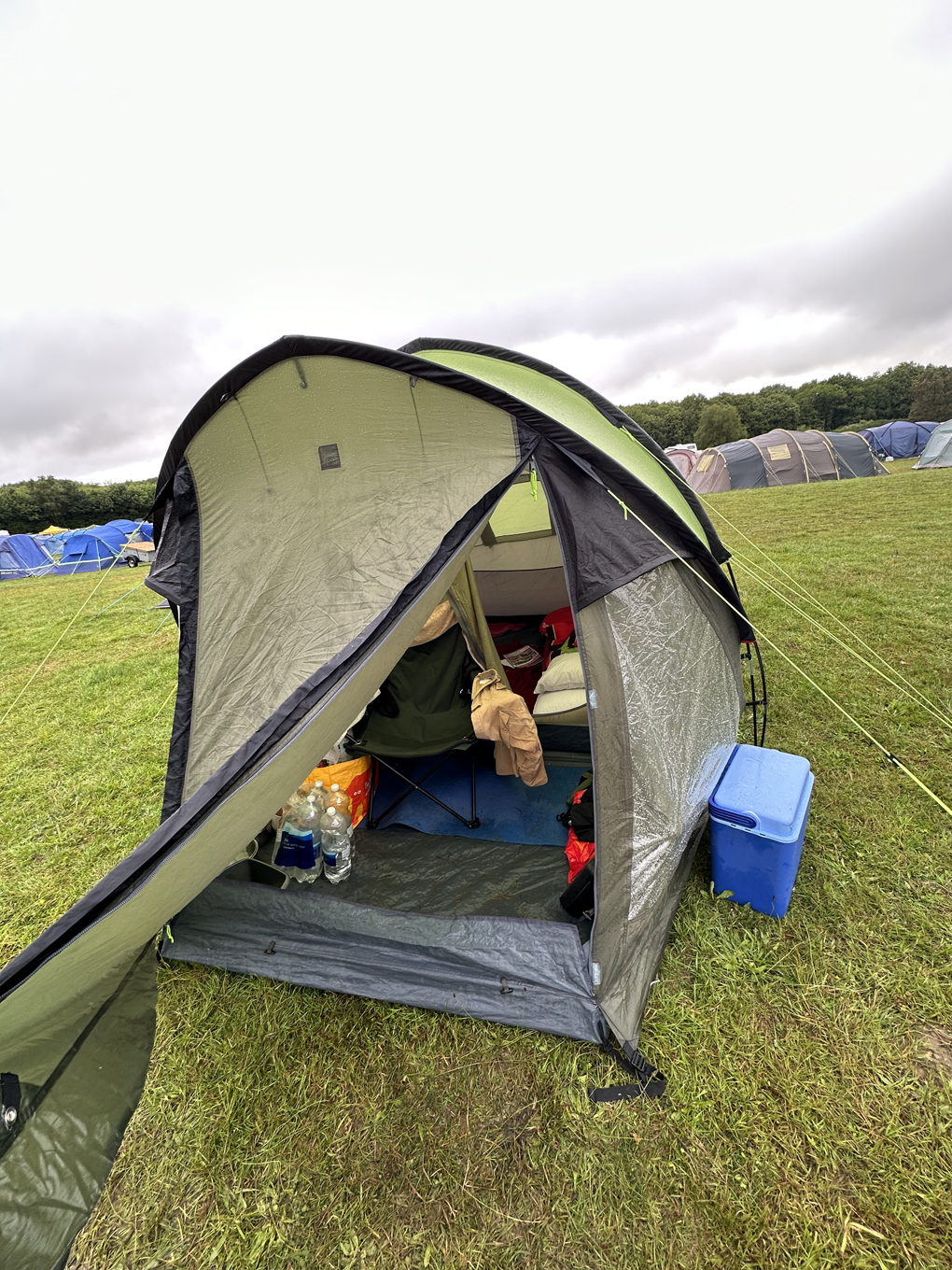 We see a medium sized tent pitched on a  New Wine village at the Kent County Showground