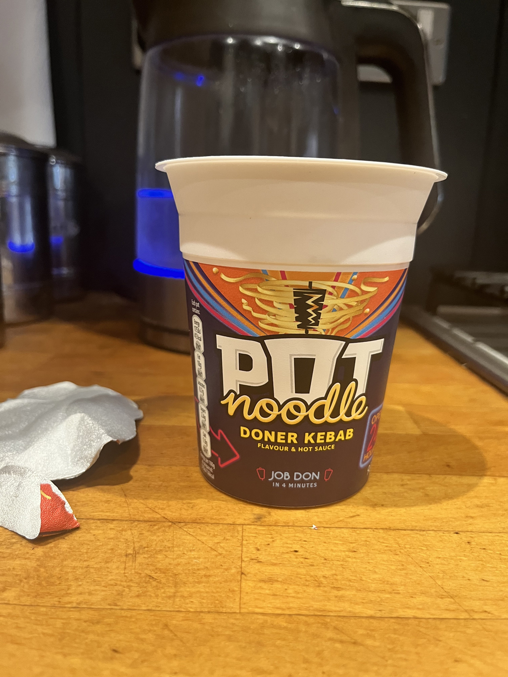 A doner kebab flavour pot noodle awaiting hot water from the recently-boiled kettle behind