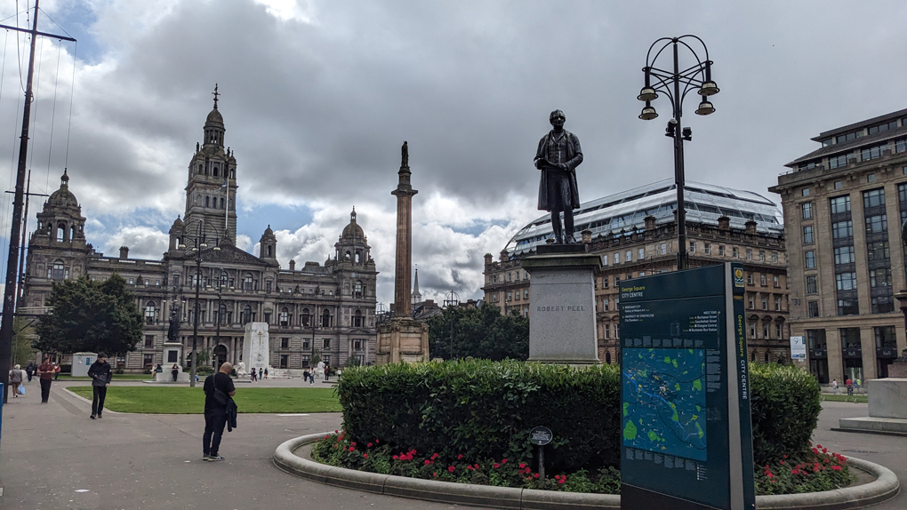 George Square in Glasgow. Statue of Robert Peel in the foreground and Glasgow City Chambers in background.