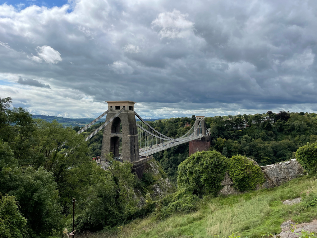 A suspension bridge over the Avon gorge. Cloudy skies above