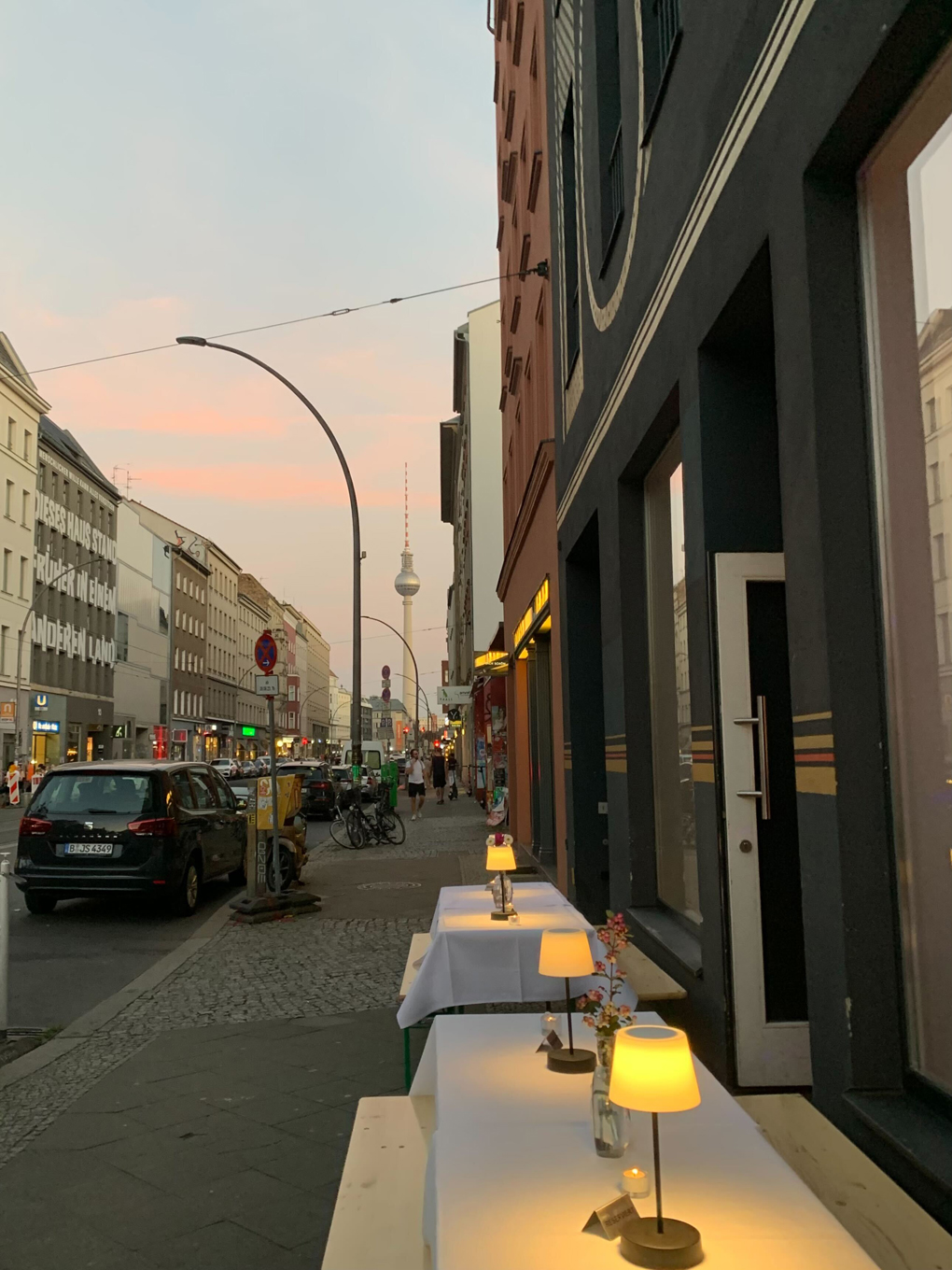 Street view at dusk with Alexanderplatz tv tower in the background.